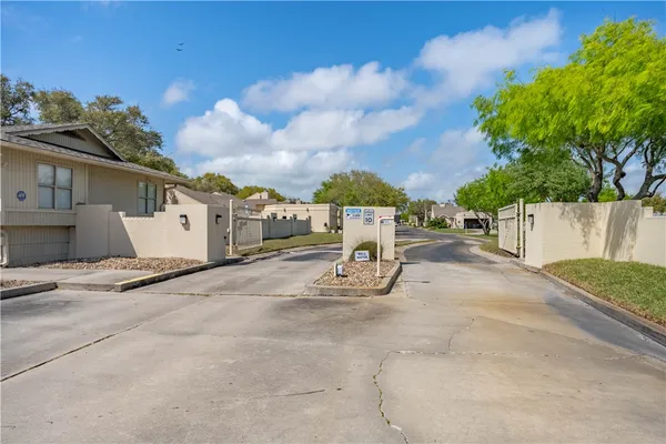 a view of a house with yard and seating space