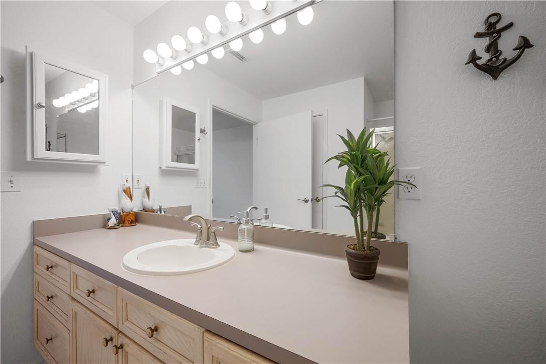 135 Santa Fe Rockport, TX 78382 - Photo 31 of 38 a bathroom with a sink a vanity and a mirror