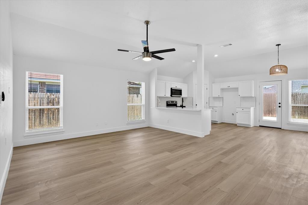 6021 Hartman Road Forest Hill, TX 76119 - Photo 4 of 27 a view of empty room with wooden floor and ceiling fan