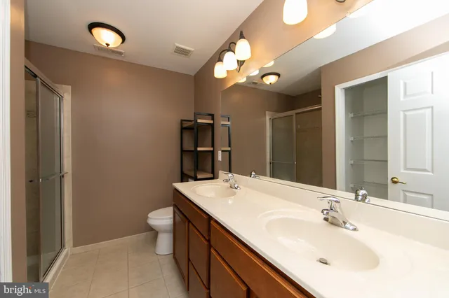 a bathroom with a sink vanity and a mirror