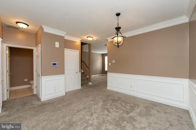 wooden floor in an empty room and a chandelier fan