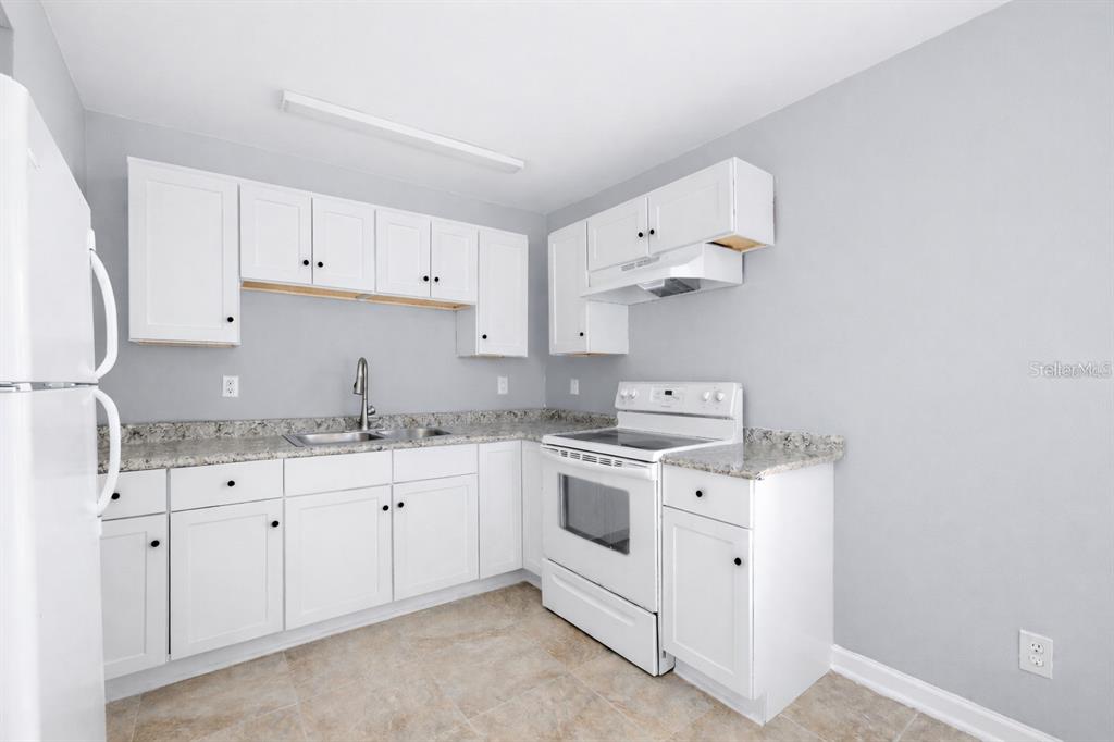 1000 Transmitter Road Panama City, FL 32401 - Photo 2 of 6 a kitchen with cabinets stainless steel appliances and sink