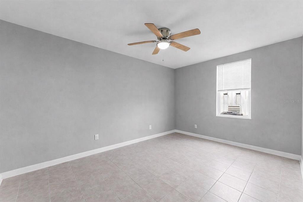1000 Transmitter Road Panama City, FL 32401 - Photo 5 of 6 an empty room with a window and ceiling fan