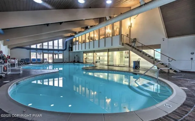 a view of a lake with a bench and trees