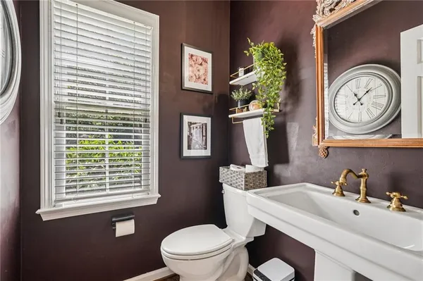 a bathroom with a toilet a sink and a mirror