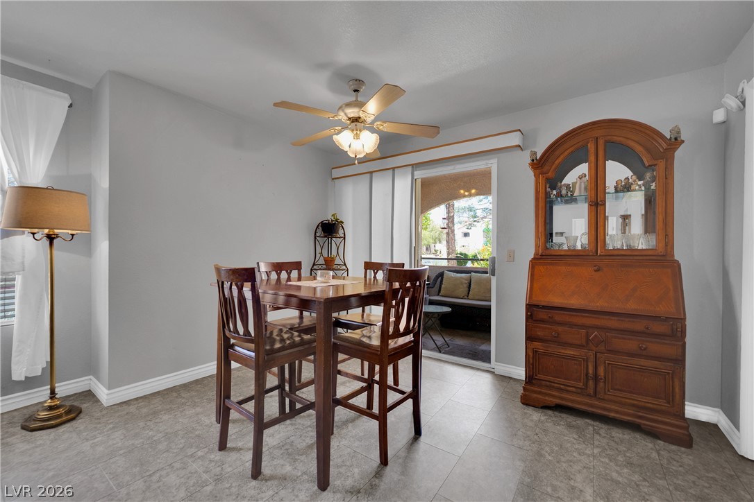 7570 West Flamingo Road, Unit 115 Las Vegas, NV 89147 - Photo 6 of 34 Natural light illuminates this cozy dining area, featuring a convenient sliding door opening to an outdoor patio.