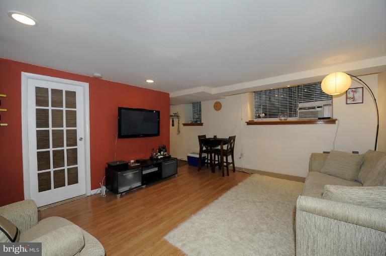 1514 17th Street Northwest, Unit 14 Washington, DC 20036 - Photo 1 of 16 a living room with furniture and a flat screen tv