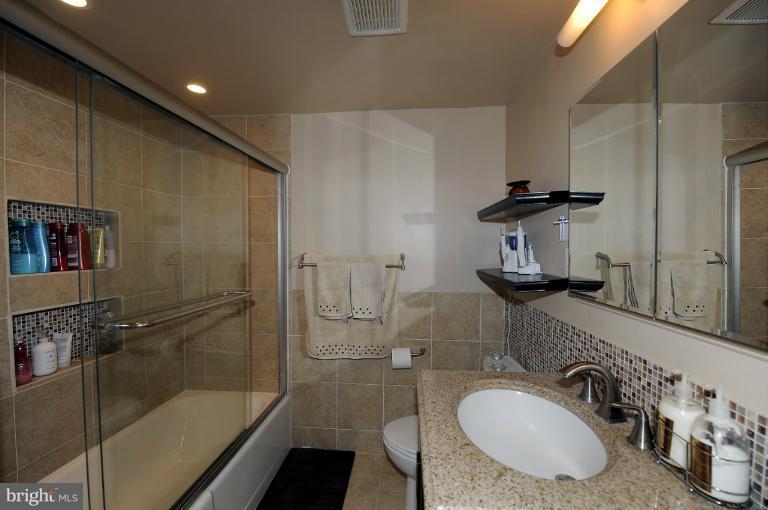 1514 17th Street Northwest, Unit 14 Washington, DC 20036 - Photo 2 of 16 a bathroom with a sink double vanity and tub