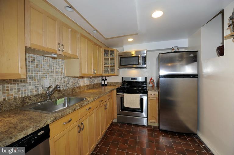 1514 17th Street Northwest, Unit 14 Washington, DC 20036 - Photo 14 of 16 a kitchen with a sink stove and refrigerator