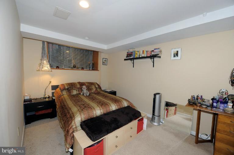 1514 17th Street Northwest, Unit 14 Washington, DC 20036 - Photo 15 of 16 a bedroom with a bed and a table in it