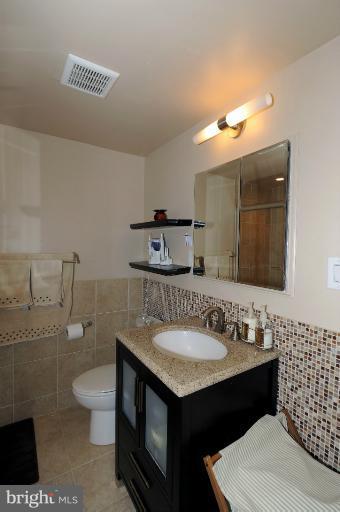 1514 17th Street Northwest, Unit 14 Washington, DC 20036 - Photo 4 of 16 a bathroom with a sink a toilet and a mirror