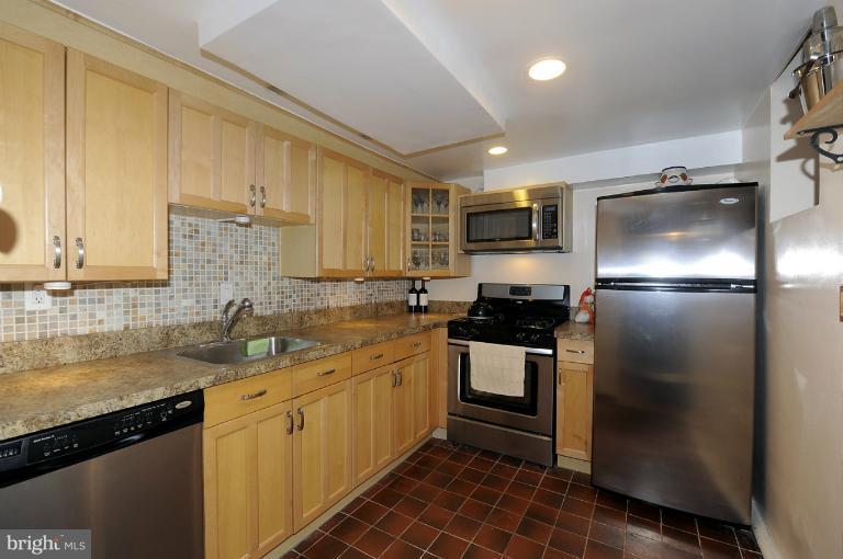 1514 17th Street Northwest, Unit 14 Washington, DC 20036 - Photo 9 of 16 a kitchen with a sink stainless steel appliances and cabinets