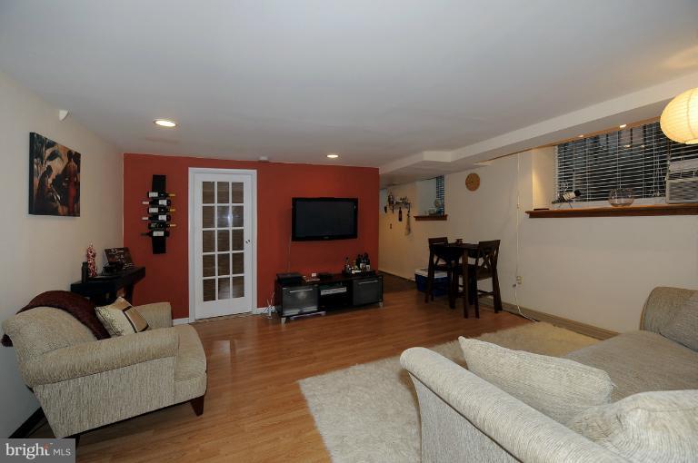 1514 17th Street Northwest, Unit 14 Washington, DC 20036 - Photo 10 of 16 a living room with furniture and a flat screen tv