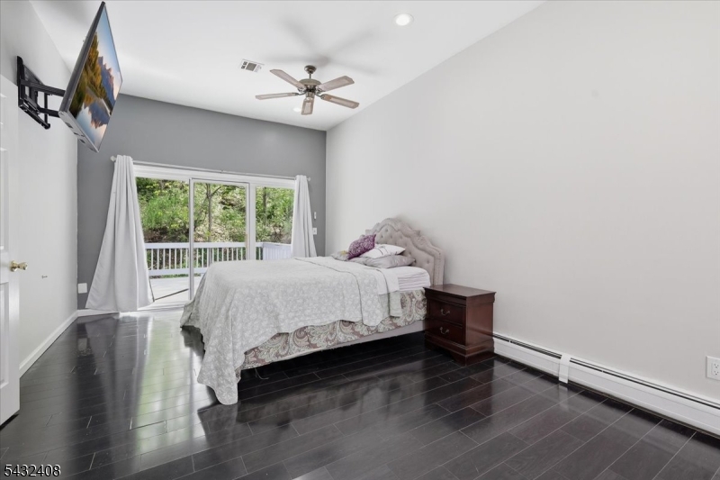 112 Knob Hill Road Hackettstown, NJ 07840 - Photo 20 of 32 a bed sitting in a bedroom next to a window
