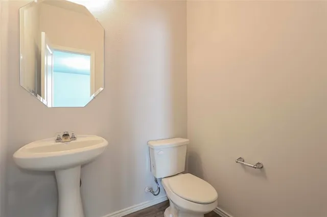 a bathroom with a sink a toilet and mirror