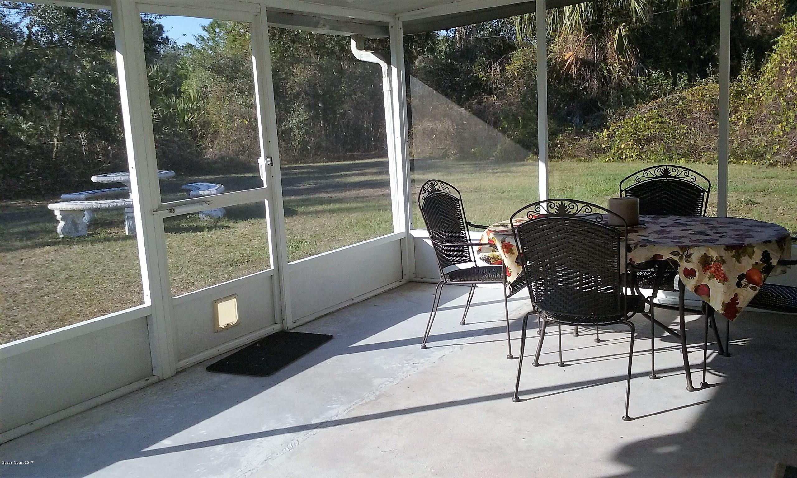 109 Tudor Road Southwest Palm Bay, FL 32908 - Photo 12 of 15 a balcony with table and chairs