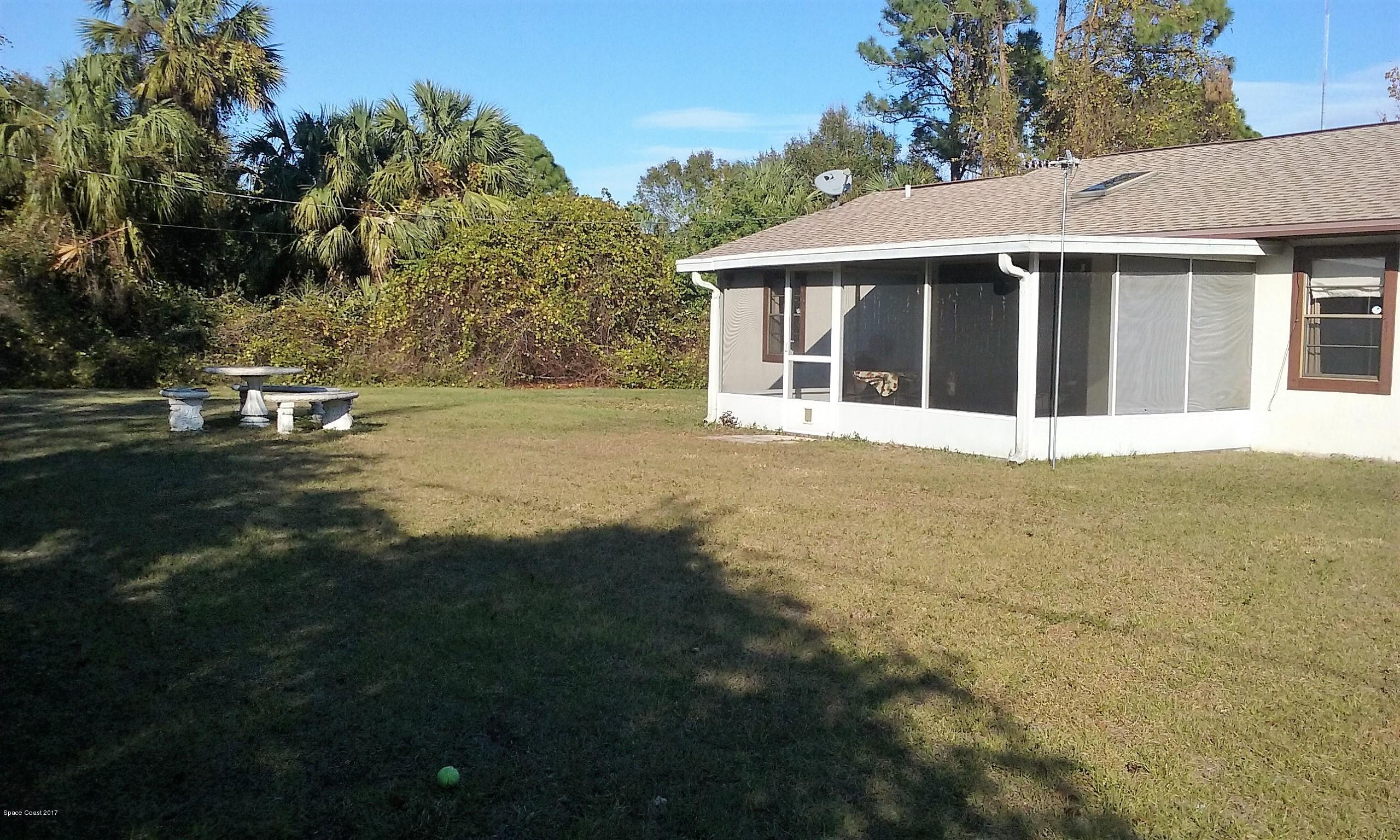109 Tudor Road Southwest Palm Bay, FL 32908 - Photo 13 of 15 a front view of a house with a garden