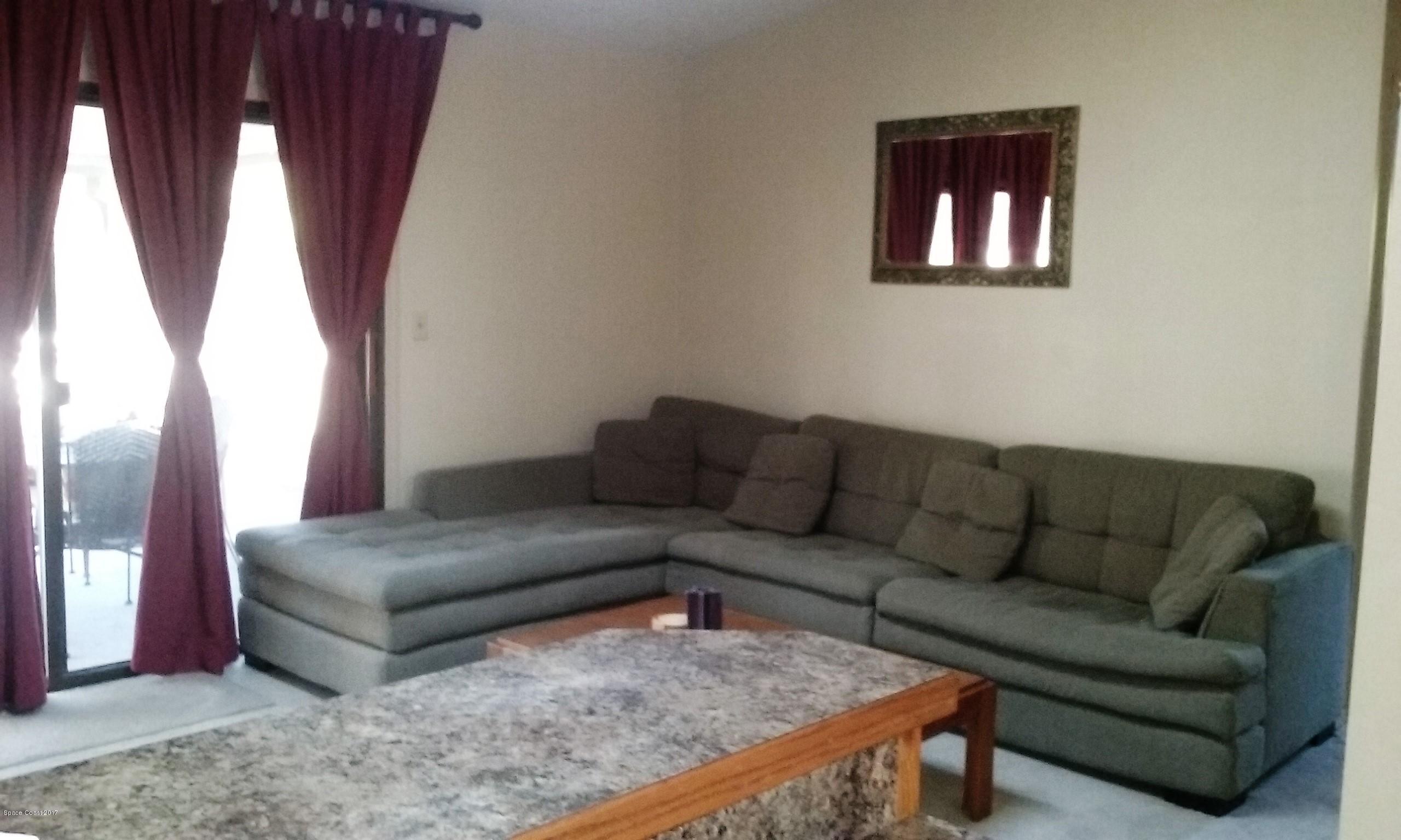 109 Tudor Road Southwest Palm Bay, FL 32908 - Photo 14 of 15 a living room with furniture and a couch