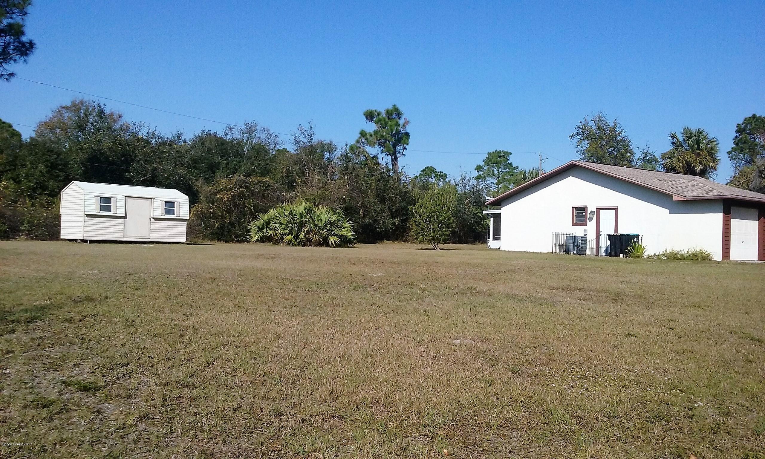 109 Tudor Road Southwest Palm Bay, FL 32908 - Photo 15 of 15 a view of a house with a yard