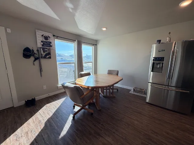 a view of a dining room with furniture window and wooden floor