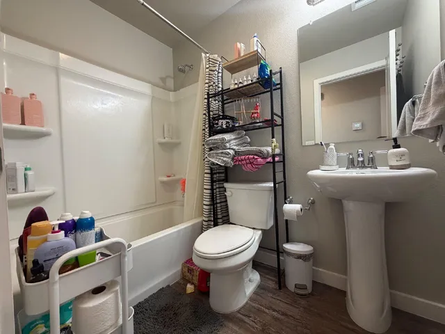 a white toilet sitting next to a bathroom sink