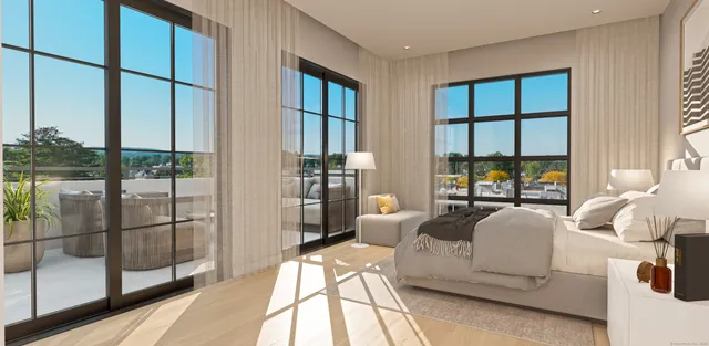 a living room with furniture and a floor to ceiling window