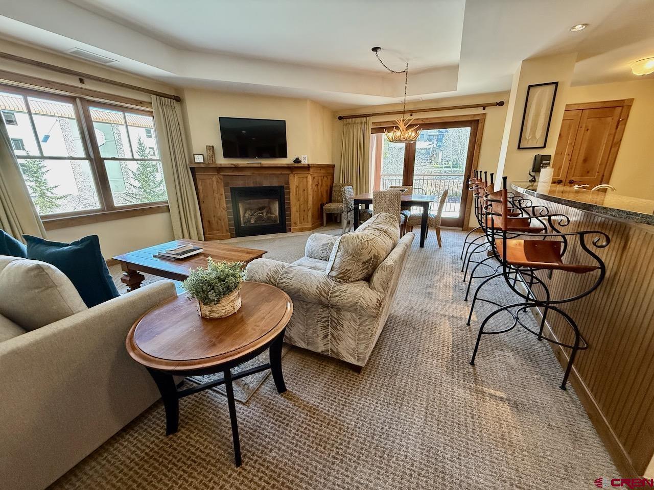 620 Gothic Road, Unit 206 Crested Butte, CO 81225 - Photo 11 of 41 a living room with furniture fireplace and a flat screen tv