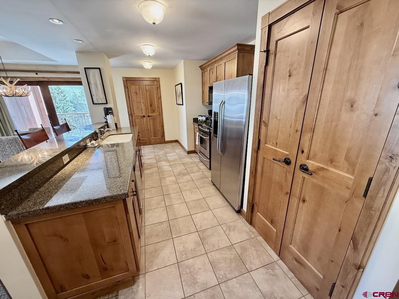 620 Gothic Road, Unit 206 Crested Butte, CO 81225 - Photo 14 of 41 a view of a refrigerator in kitchen and wooden floor