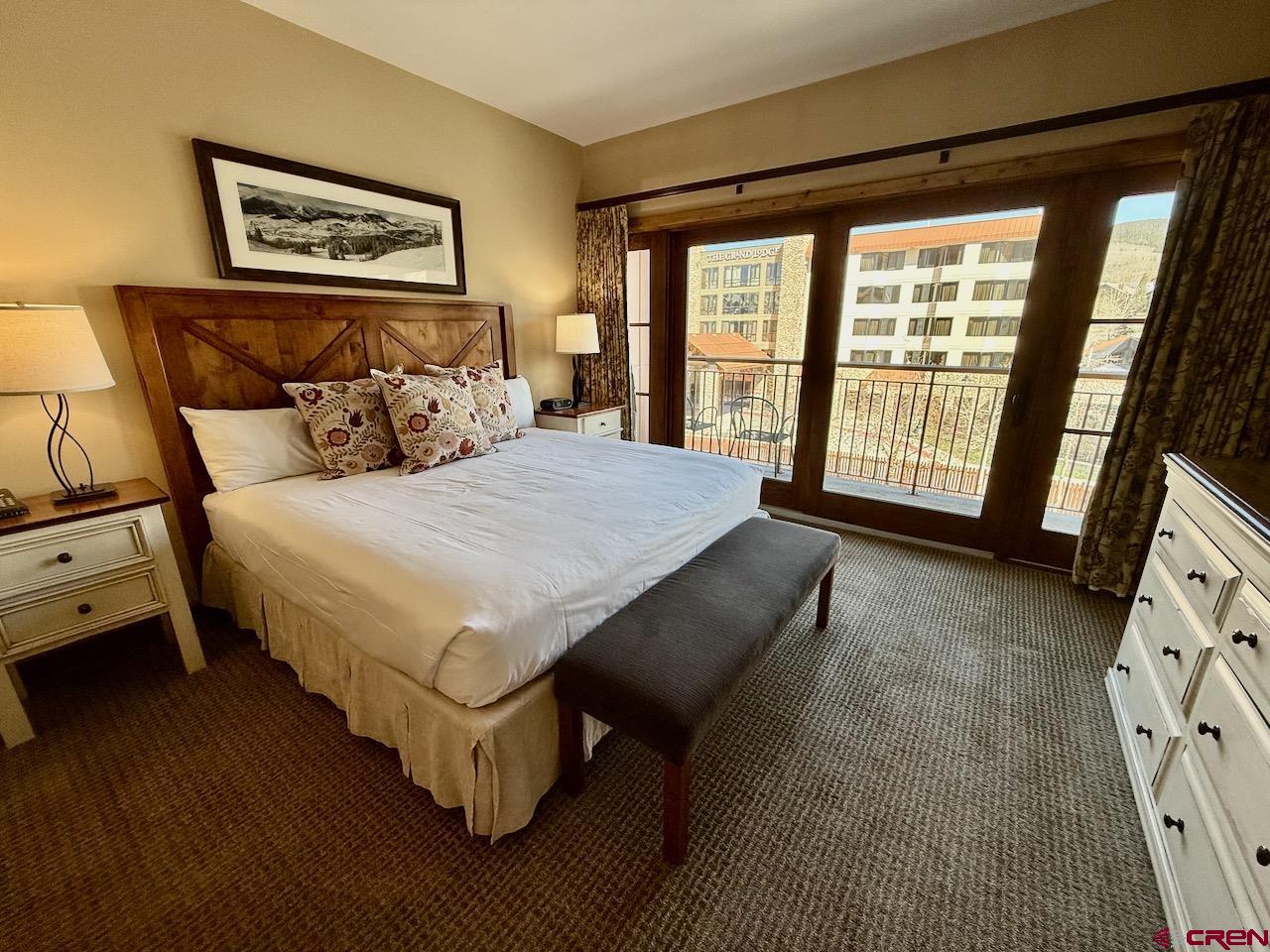 620 Gothic Road, Unit 206 Crested Butte, CO 81225 - Photo 19 of 41 a bedroom with a bed and a large window