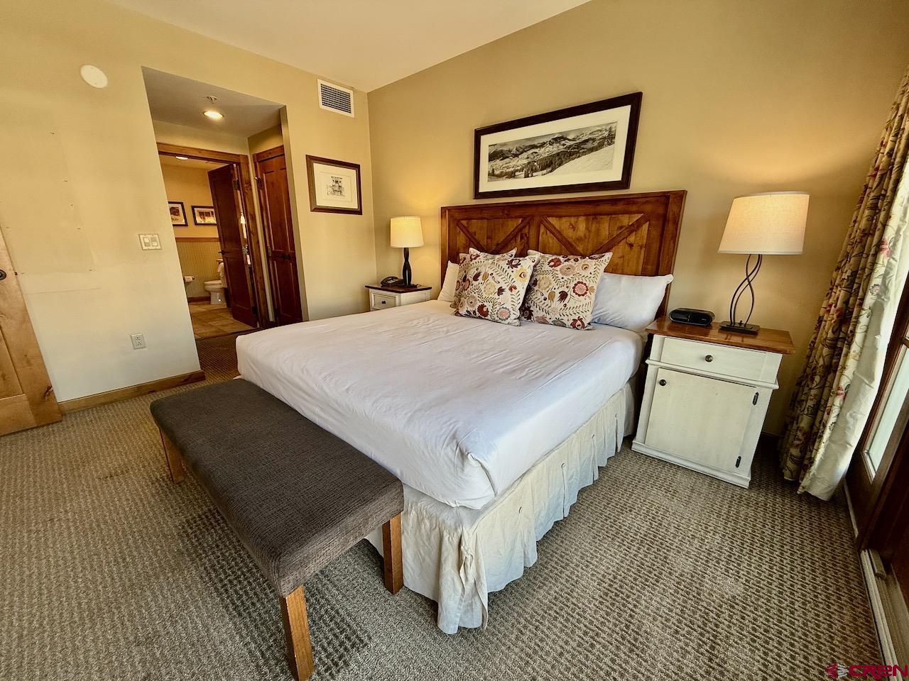 620 Gothic Road, Unit 206 Crested Butte, CO 81225 - Photo 20 of 41 a bed room with a bed and a mirror