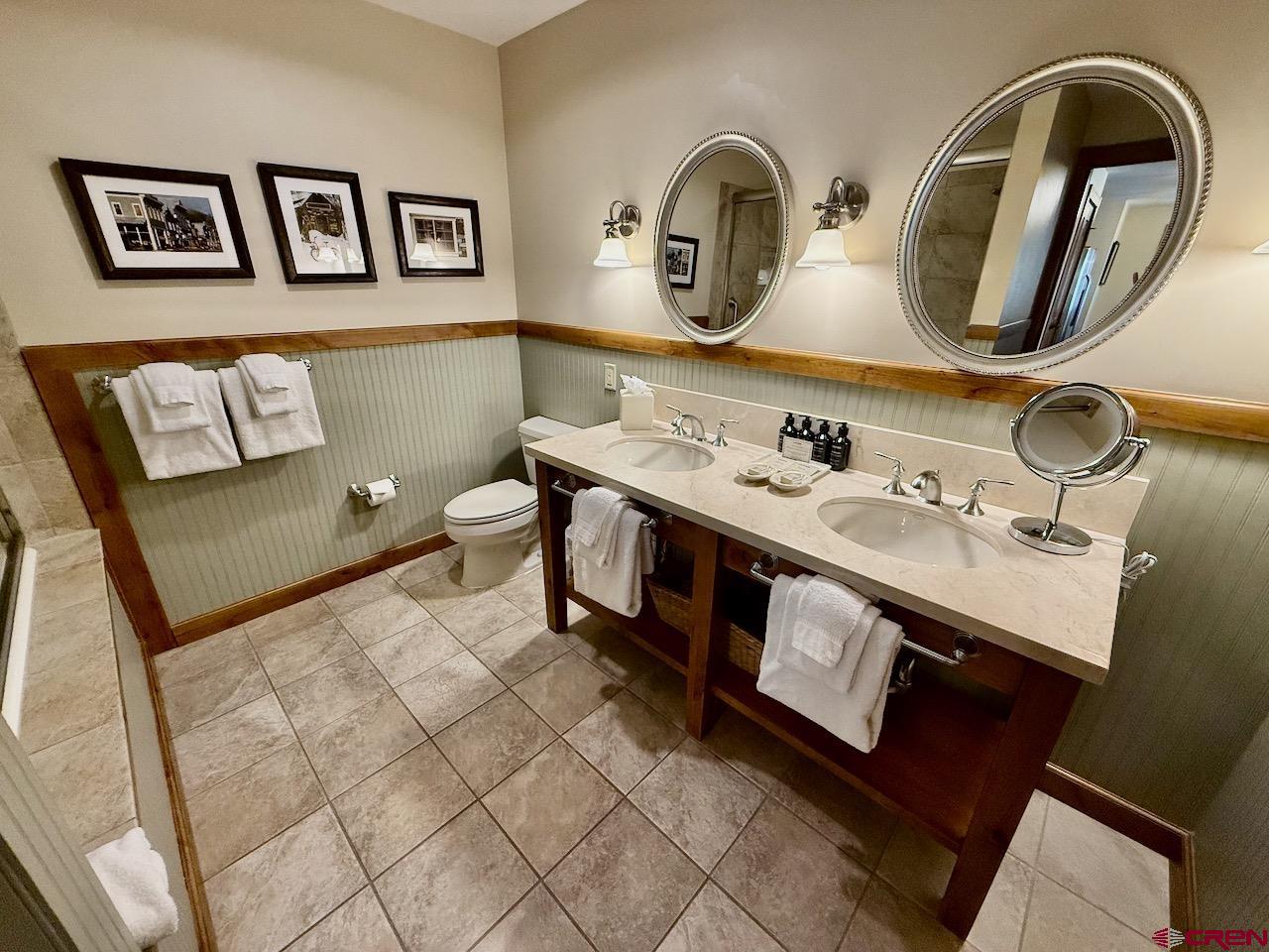 620 Gothic Road, Unit 206 Crested Butte, CO 81225 - Photo 26 of 41 a bathroom with a toilet sink and mirror
