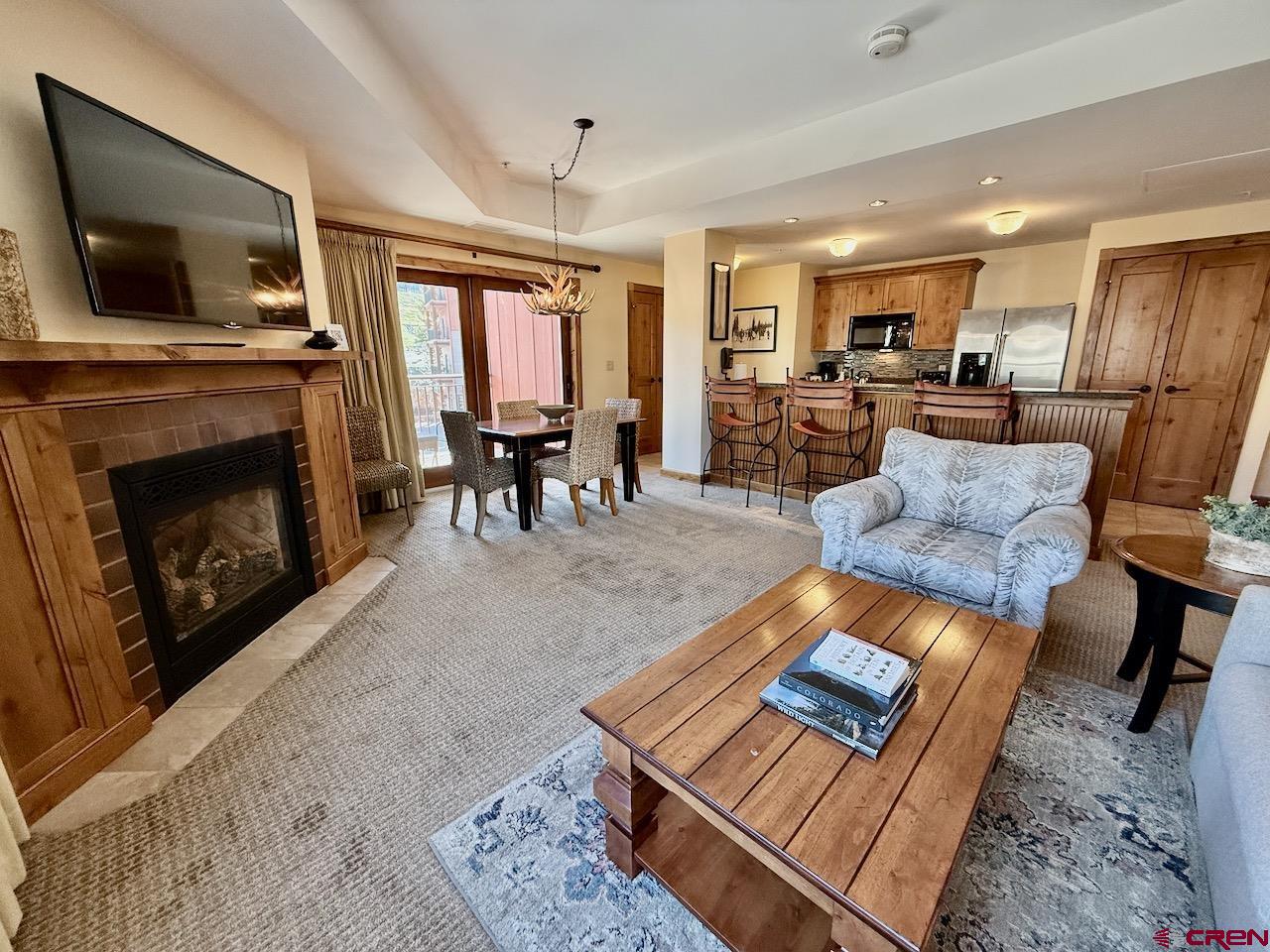 620 Gothic Road, Unit 206 Crested Butte, CO 81225 - Photo 8 of 41 a living room with furniture and a fireplace