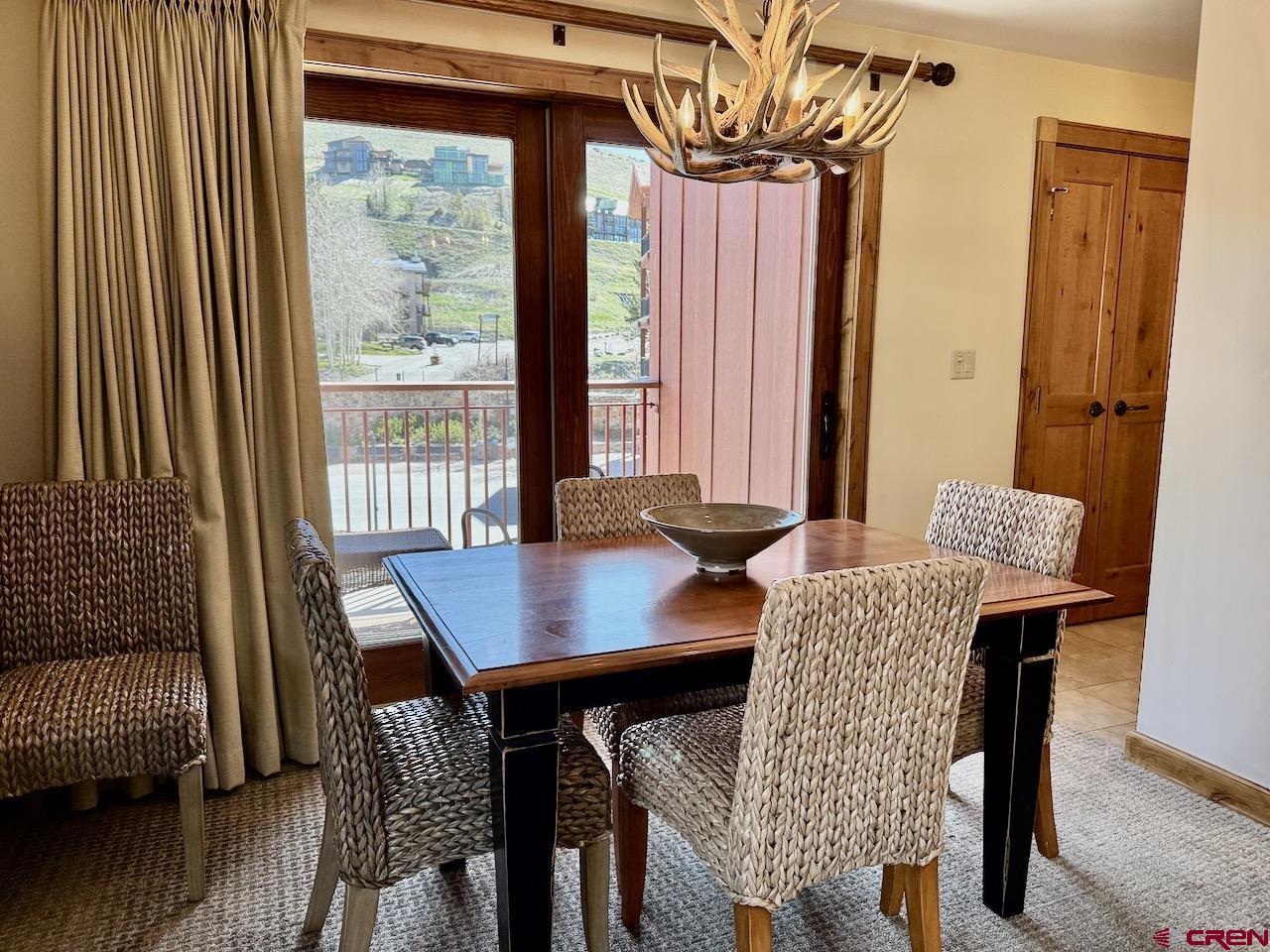 620 Gothic Road, Unit 206 Crested Butte, CO 81225 - Photo 9 of 41 a view of a dining room with furniture and wooden floor