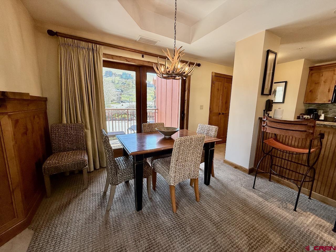 620 Gothic Road, Unit 206 Crested Butte, CO 81225 - Photo 10 of 41 a view of a a dining room with furniture window and wooden floor