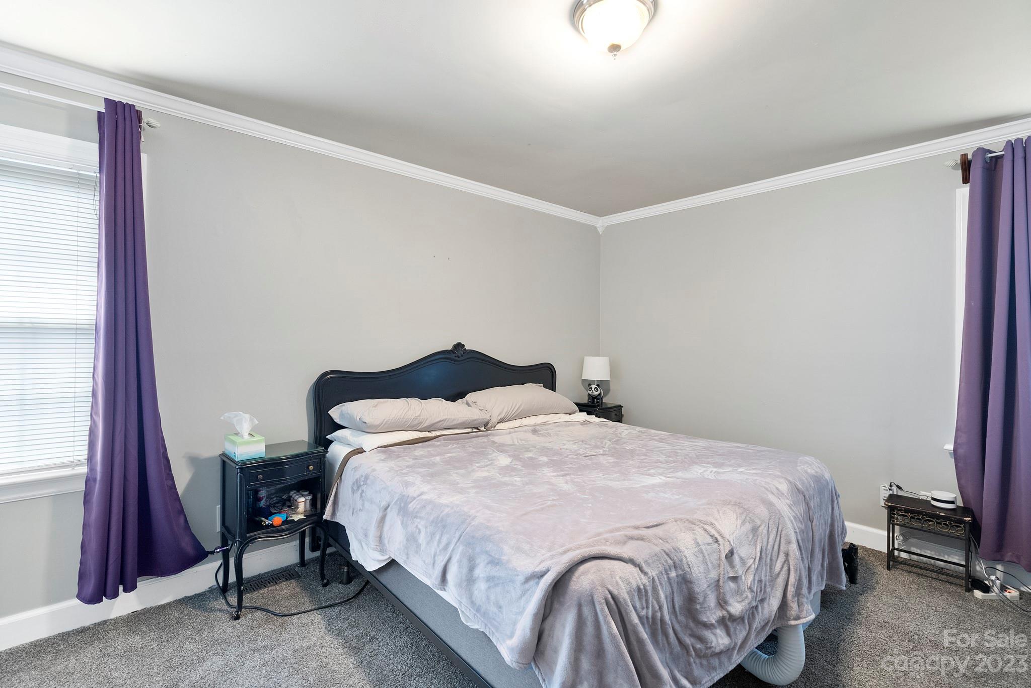 6501 Wynbrook Way Raleigh, NC 27612 - Photo 26 of 30 a bedroom with a bed and a mirror