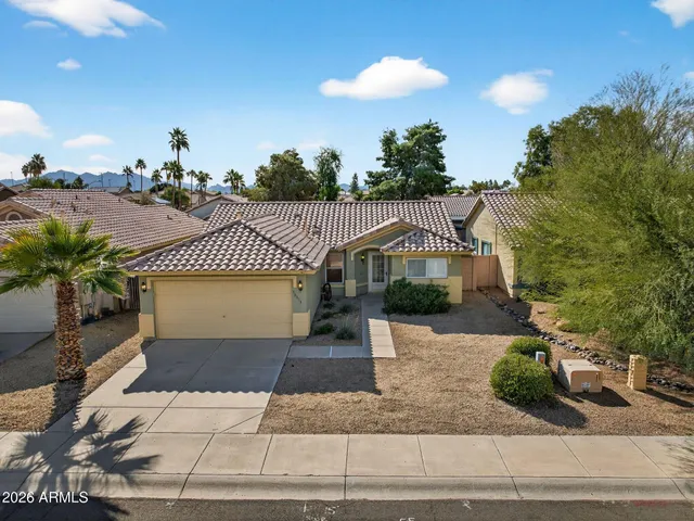 a front view of a house with a yard and a garage