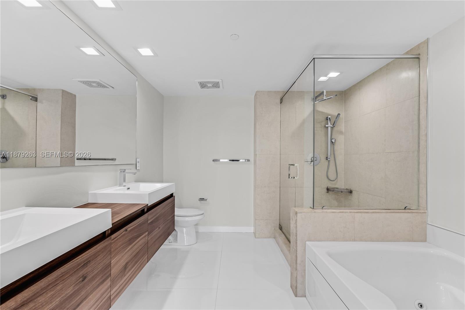 50 Biscayne Boulevard, Unit 3601 Miami, FL 33132 - Photo 26 of 83 a bathroom with a tub shower sink and mirror
