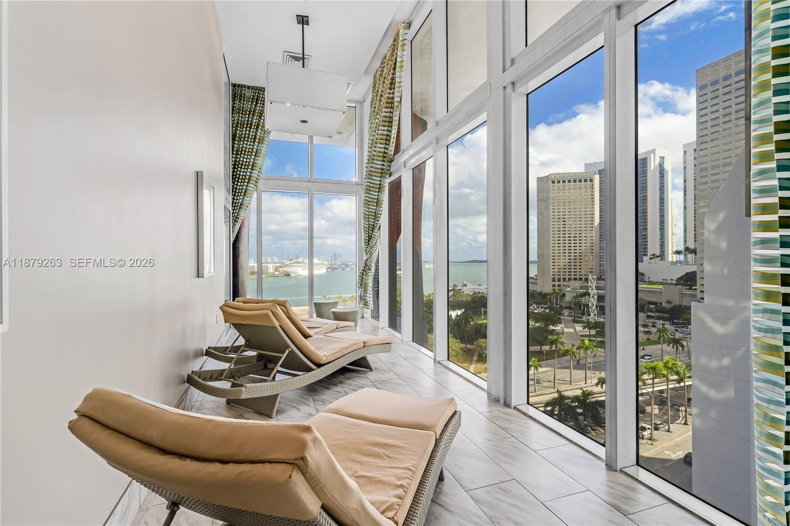 50 Biscayne Boulevard, Unit 3601 Miami, FL 33132 - Photo 63 of 83 a living room with furniture and a floor to ceiling window