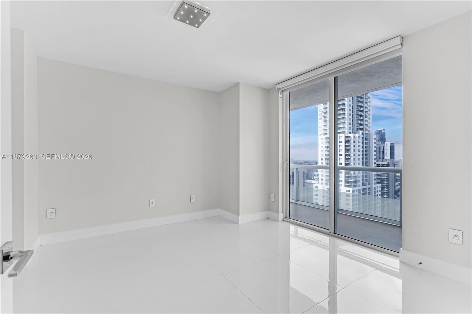 50 Biscayne Boulevard, Unit 3601 Miami, FL 33132 - Photo 10 of 83 a view of an empty room with glass door