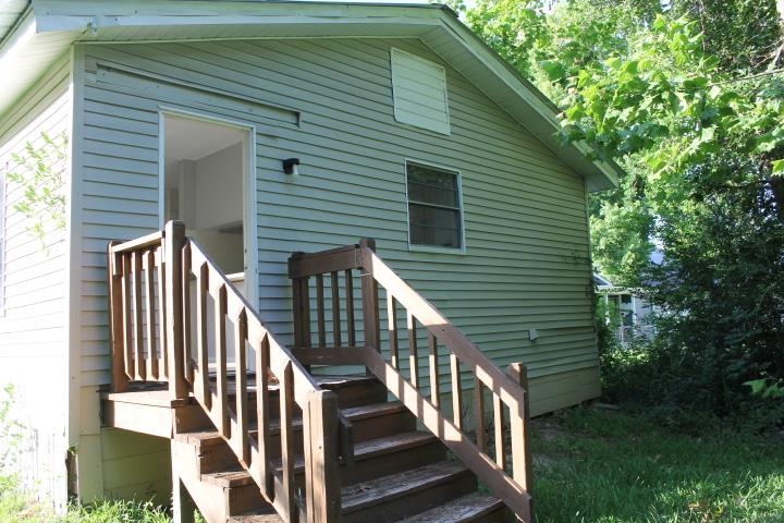 875 Woodrow Street Silsbee, TX 77656 - Photo 8 of 30 a view of house with wooden deck and a small yard