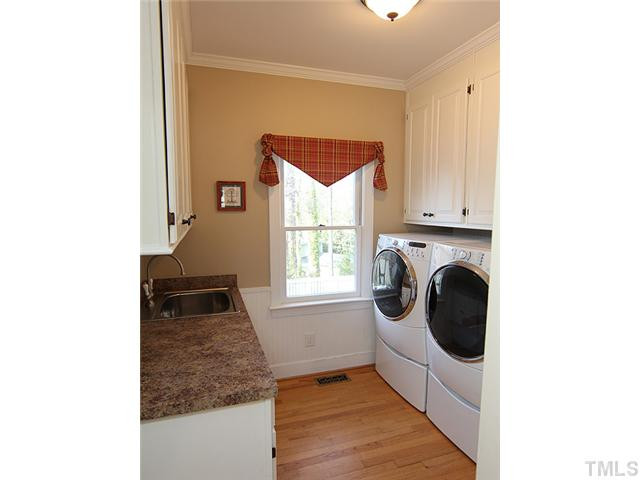 2512 Ashley Court Raleigh, NC 27607 - Photo 9 of 24 And the redesign continued into wonderful additional cabinet space and work space in the laundry room - with a great view of the back yard. Laundry Room