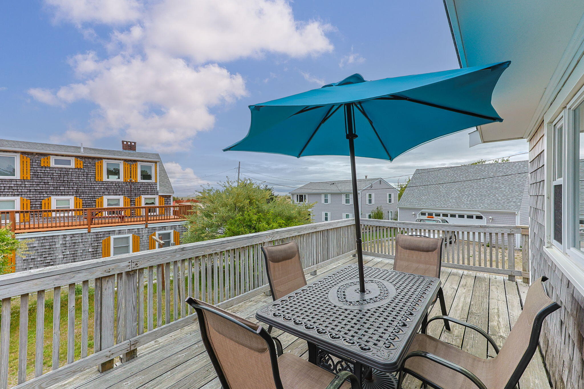 357 Phillips Road Sandwich, MA 02563 - Photo 4 of 28 a view of balcony with furniture and umbrella