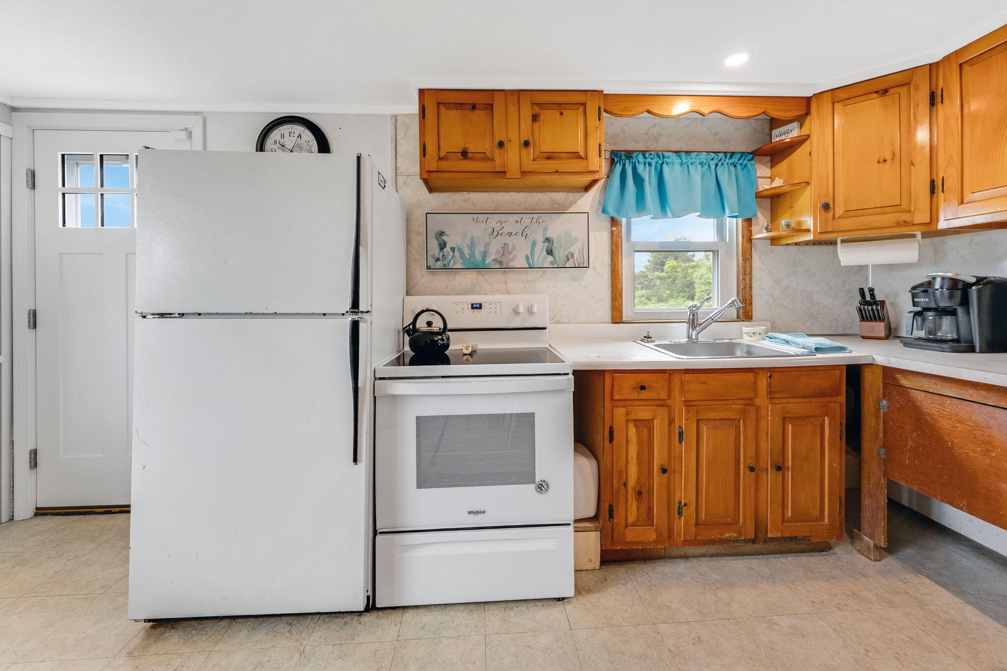 357 Phillips Road Sandwich, MA 02563 - Photo 6 of 28 a kitchen with a refrigerator sink and cabinets