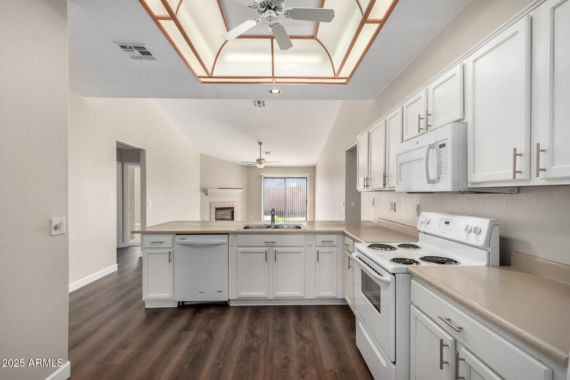 501 West Mesquite Street Gilbert, AZ 85233 - Photo 11 of 24 a kitchen with stainless steel appliances granite countertop a sink dishwasher a stove and white cabinets with wooden floor