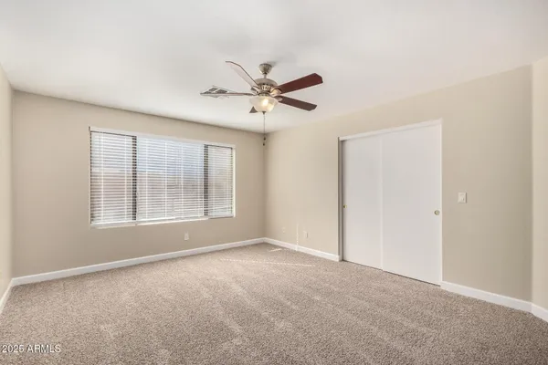 a view of a livingroom with a ceiling fan and window