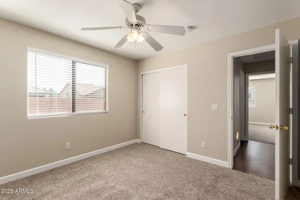 a view of a livingroom with a ceiling fan and window