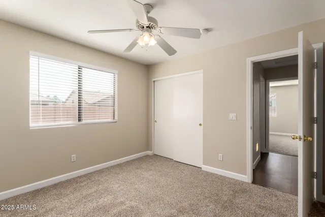 a view of a livingroom with a ceiling fan and window