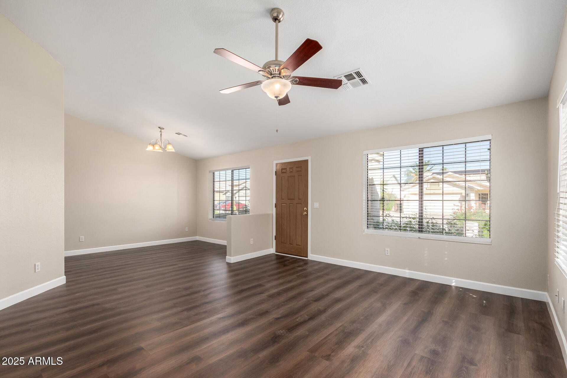 501 West Mesquite Street Gilbert, AZ 85233 - Photo 3 of 24 a view of an empty room with wooden floor and a window