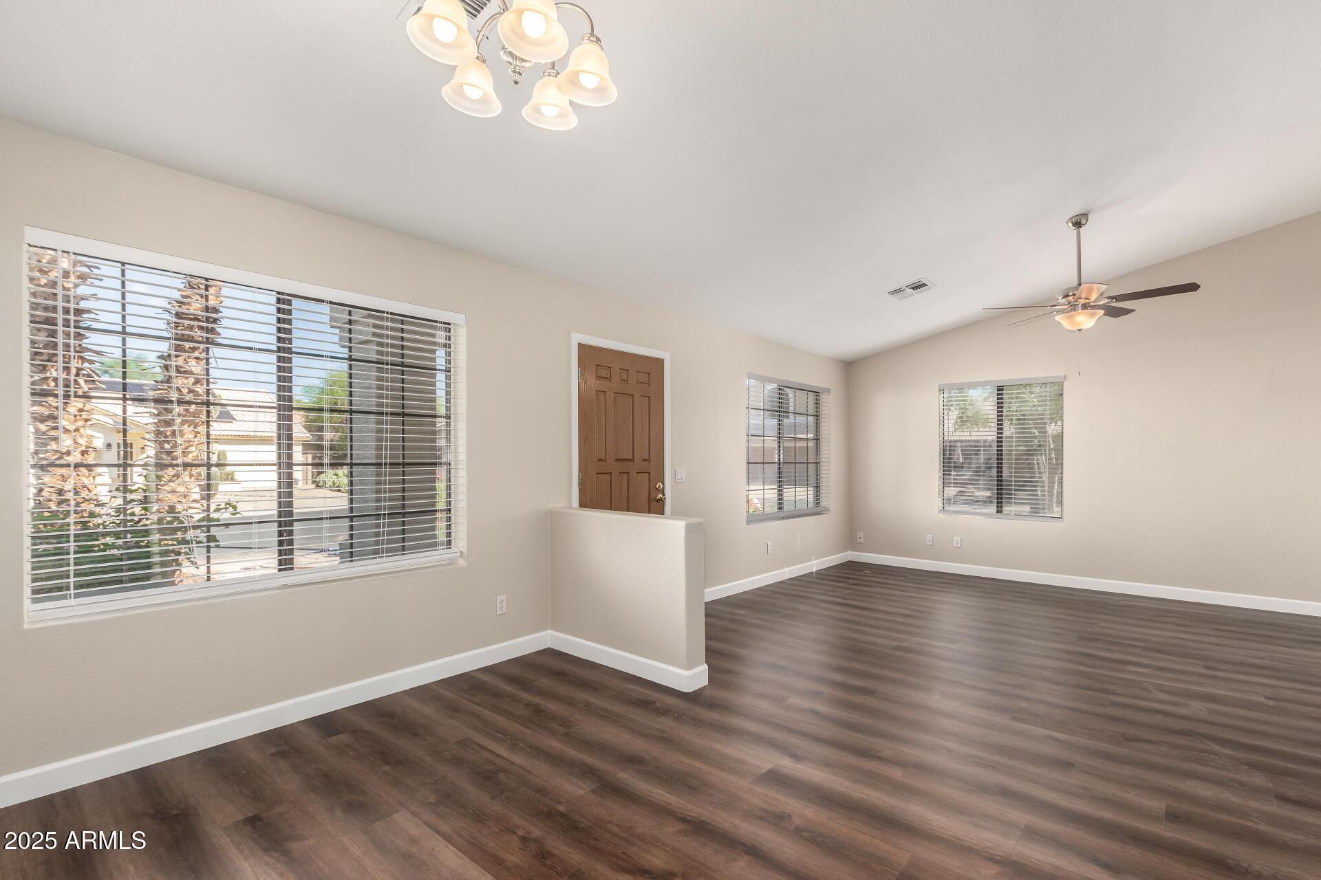 501 West Mesquite Street Gilbert, AZ 85233 - Photo 4 of 24 a view of an empty room with wooden floor and a window