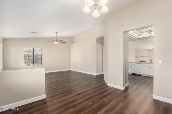 a view of a room with wooden floor and window
